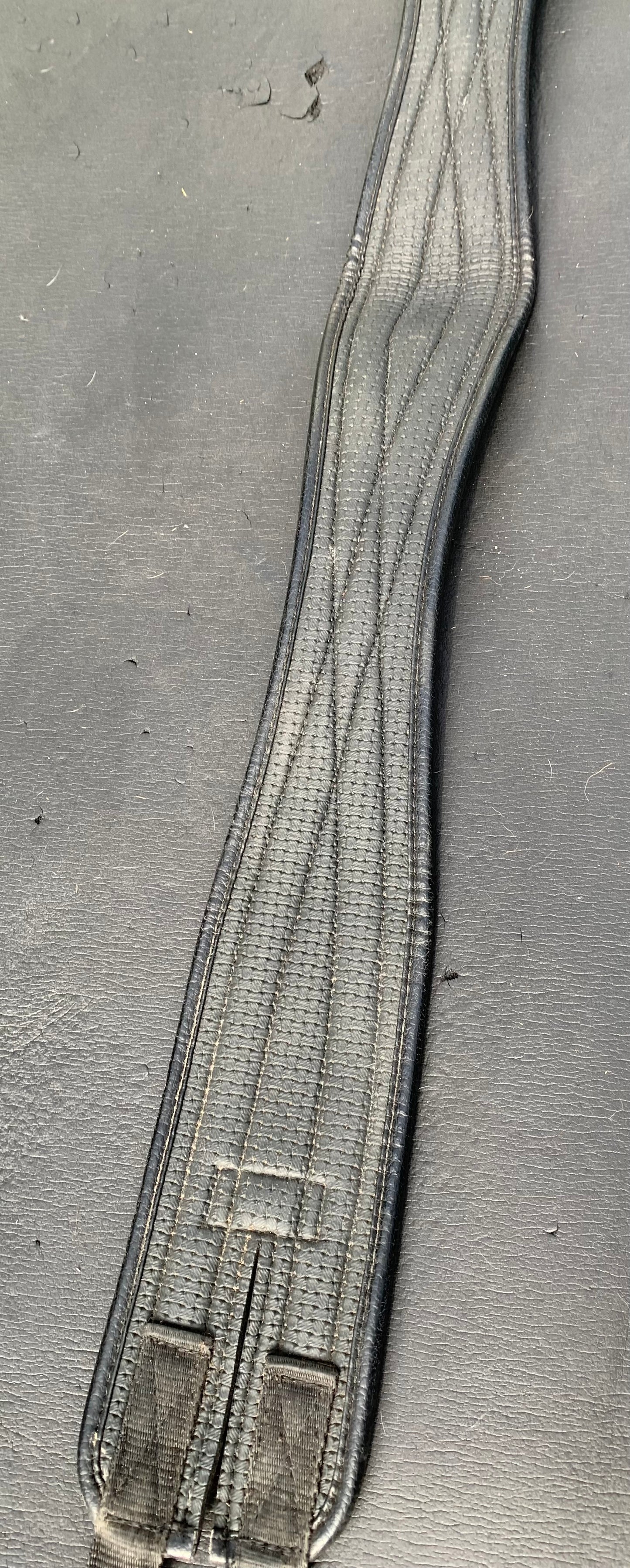 Black synthetic 46” anatomical/shaped girth elasticated at one end