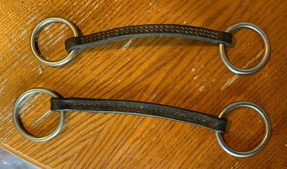 X2 brown leather Irish Martingales 
Designed to keep the reins closer together for more control, and to prevent the reins from coming over the horse's head in the event of a fall