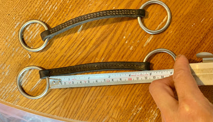 X2 brown leather Irish Martingales 
Designed to keep the reins closer together for more control, and to prevent the reins from coming over the horse's head in the event of a fall