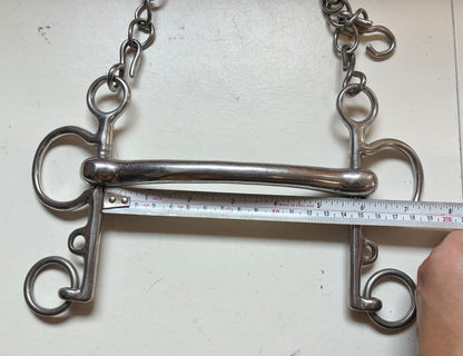 rugby Pelham bit with a solid curved mullen mouth and an attached curb chain with a rubber guard

size 5.5”