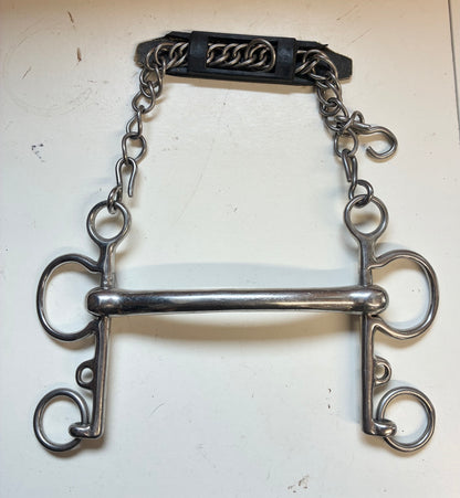 rugby Pelham bit with a solid curved mullen mouth and an attached curb chain with a rubber guard

size 5.5”